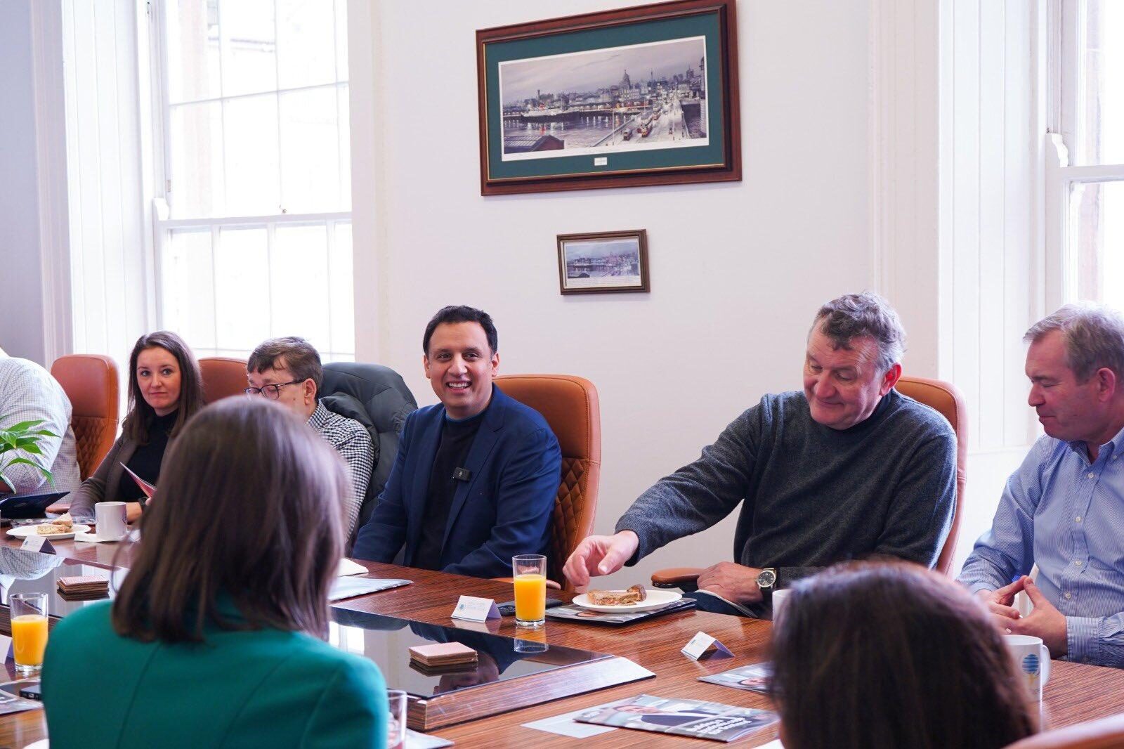Anas Sarwar sitting at a boardroom table with business leaders